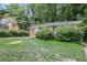 Charming brick home with stone walkway, surrounded by mature trees and greenery at 1279 Kenilworth Sw Dr, Atlanta, GA 30310