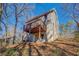 Home's rear exterior featuring a raised wooden deck and a backyard surrounded by trees at 169 Holly Ct, Loganville, GA 30052