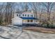 Charming two-story home with a welcoming front porch and a spacious driveway nestled among trees at 169 Holly Ct, Loganville, GA 30052