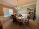 A formal dining room bathed in natural light with a chandelier creates a comfortable eating space at 3139 Tuscan Ridge Dr, Snellville, GA 30039