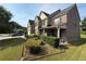 Corner view of two-story brick home with red shutters, covered front porch, manicured lawn and landscaping at 3139 Tuscan Ridge Dr, Snellville, GA 30039