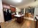 A spacious kitchen features a center island, wood cabinetry, and black refrigerator, great for cooking and entertaining at 3139 Tuscan Ridge Dr, Snellville, GA 30039