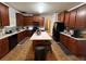 Spacious kitchen featuring dark cabinetry, granite countertops, and a central island at 3139 Tuscan Ridge Dr, Snellville, GA 30039