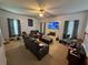 A cozy living room featuring a fireplace, ceiling fan, carpet flooring and comfortable seating area at 3139 Tuscan Ridge Dr, Snellville, GA 30039