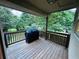 Enjoy outdoor cooking on this wooden deck with a grill, overlooking the backyard at 4007 Stacy Ln, Snellville, GA 30039