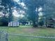 Expansive backyard featuring a storage shed, playset, and ample space for outdoor activities at 4007 Stacy Ln, Snellville, GA 30039