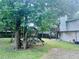 Well-maintained backyard with a playset, mature trees, and access to the back deck at 4007 Stacy Ln, Snellville, GA 30039