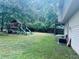 Large backyard with playset and mature trees offering shade at 4007 Stacy Ln, Snellville, GA 30039