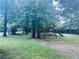 Spacious backyard featuring a playset and mature trees at 4007 Stacy Ln, Snellville, GA 30039