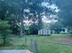 A verdant backyard featuring mature trees, a shed, and a fenced-in area at 4007 Stacy Ln, Snellville, GA 30039