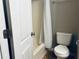 Bathroom featuring a white shower curtain, white toilet, and doorway at 4007 Stacy Ln, Snellville, GA 30039
