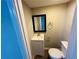 Half bathroom featuring a vanity, mirror, toilet, and chrome accents at 4007 Stacy Ln, Snellville, GA 30039
