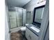 Bathroom with vinyl flooring, a white sink, toilet, and a shower stall at 4007 Stacy Ln, Snellville, GA 30039