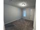 This bedroom features carpet, light-colored walls, one window and one closet at 4007 Stacy Ln, Snellville, GA 30039