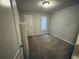 This bedroom features carpet, light-colored walls, one window and one closet at 4007 Stacy Ln, Snellville, GA 30039