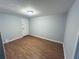 Bedroom with hardwood flooring, light fixture, and fresh paint at 4007 Stacy Ln, Snellville, GA 30039
