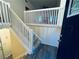 Entryway with stairs and white railing and plank flooring, leading to the upper level at 4007 Stacy Ln, Snellville, GA 30039
