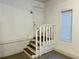 Basement access via stairs, featuring white walls and wood grain steps at 4007 Stacy Ln, Snellville, GA 30039