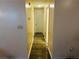 Hallway with plank flooring, access to storage and interior doors at 4007 Stacy Ln, Snellville, GA 30039