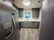 Modern kitchen with stainless steel appliances, gray cabinetry, and quartz countertops at 4007 Stacy Ln, Snellville, GA 30039