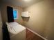 Functional laundry room with washer, dryer, storage and window at 4007 Stacy Ln, Snellville, GA 30039