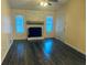 Cozy living room with stone fireplace, plank flooring, and plenty of natural light at 4007 Stacy Ln, Snellville, GA 30039