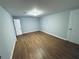 A spacious living room featuring light blue walls and wood-look flooring at 4007 Stacy Ln, Snellville, GA 30039