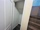 View of a closet underneath the stairs, with a closet rod and door at 4007 Stacy Ln, Snellville, GA 30039
