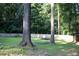 The backyard features a trampoline, surrounded by a wood fence and mature trees at 4640 Calleigh Way, Snellville, GA 30039