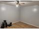 Bright bedroom features wood floors, ceiling fan, and ample space for fitness equipment at 4640 Calleigh Way, Snellville, GA 30039