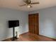 Bedroom with a television, a lamp, a closet, blue walls, and a wooden floor at 4640 Calleigh Way, Snellville, GA 30039
