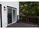 A well maintained home deck showing wood railing, ample sunlight and backyard trees at 4640 Calleigh Way, Snellville, GA 30039