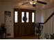 Inviting entrance with a wood door with glass panels and a decorative ceiling fan at 4640 Calleigh Way, Snellville, GA 30039
