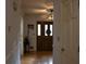 Bright foyer with wood floors and an entrance door with glass panels and a ceiling fan at 4640 Calleigh Way, Snellville, GA 30039