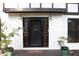 Charming front door with decorative wreath and small potted plants flanking the entry at 4640 Calleigh Way, Snellville, GA 30039