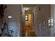 Bright hallway featuring hardwood floors, base molding, and a view of the bathroom at 4640 Calleigh Way, Snellville, GA 30039