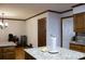 View of kitchen with wood cabinets, hardwood floors, and granite countertops on the island at 4640 Calleigh Way, Snellville, GA 30039