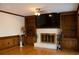 Living room with fireplace, built-in shelving, hardwood floors, and a ceiling fan at 4640 Calleigh Way, Snellville, GA 30039