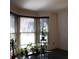 Bright living room with bay window, plants, and wood floors at 4640 Calleigh Way, Snellville, GA 30039