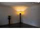 Living room with black tile flooring, plant on a pedestal, and decorative floor lamp at 4640 Calleigh Way, Snellville, GA 30039