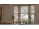 Bright living room with bay window, plants, and wood floors at 4640 Calleigh Way, Snellville, GA 30039