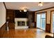 Living room with fireplace, built-in shelving, hardwood floors, ceiling fan and sliding glass doors at 4640 Calleigh Way, Snellville, GA 30039