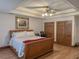 Spacious main bedroom with tray ceiling, ceiling fan, and wood-look floors at 4640 Calleigh Way, Snellville, GA 30039