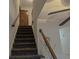 Carpeted staircase leading to the second floor with a wood banister at 4640 Calleigh Way, Snellville, GA 30039