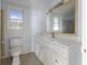 Updated bathroom features marble floors, and white cabinets, and a large mirror above the vanity at 1321 Mcclelland Ave, Atlanta, GA 30344