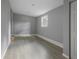 Bedroom with gray walls, luxury vinyl plank floors, baseboard trim, and a window at 1321 Mcclelland Ave, Atlanta, GA 30344