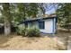 Charming home with light siding, blue trim, and a cozy front yard with mature trees and bushes at 1321 Mcclelland Ave, Atlanta, GA 30344