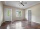 A light-filled living room with polished wood floors, neutral walls, and a decorative front door and ceiling fan at 1321 Mcclelland Ave, Atlanta, GA 30344