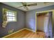 Neutral bedroom featuring wood floors, a ceiling fan, and a closet for storage at 1342 Peggy Nw Ln, Conyers, GA 30012