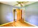 Neutral bedroom featuring wood floors, a ceiling fan, and a closet at 1342 Peggy Nw Ln, Conyers, GA 30012